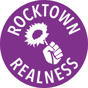 Rocktown Realness logo: a raised fist holding a sunflower inside a purple circle